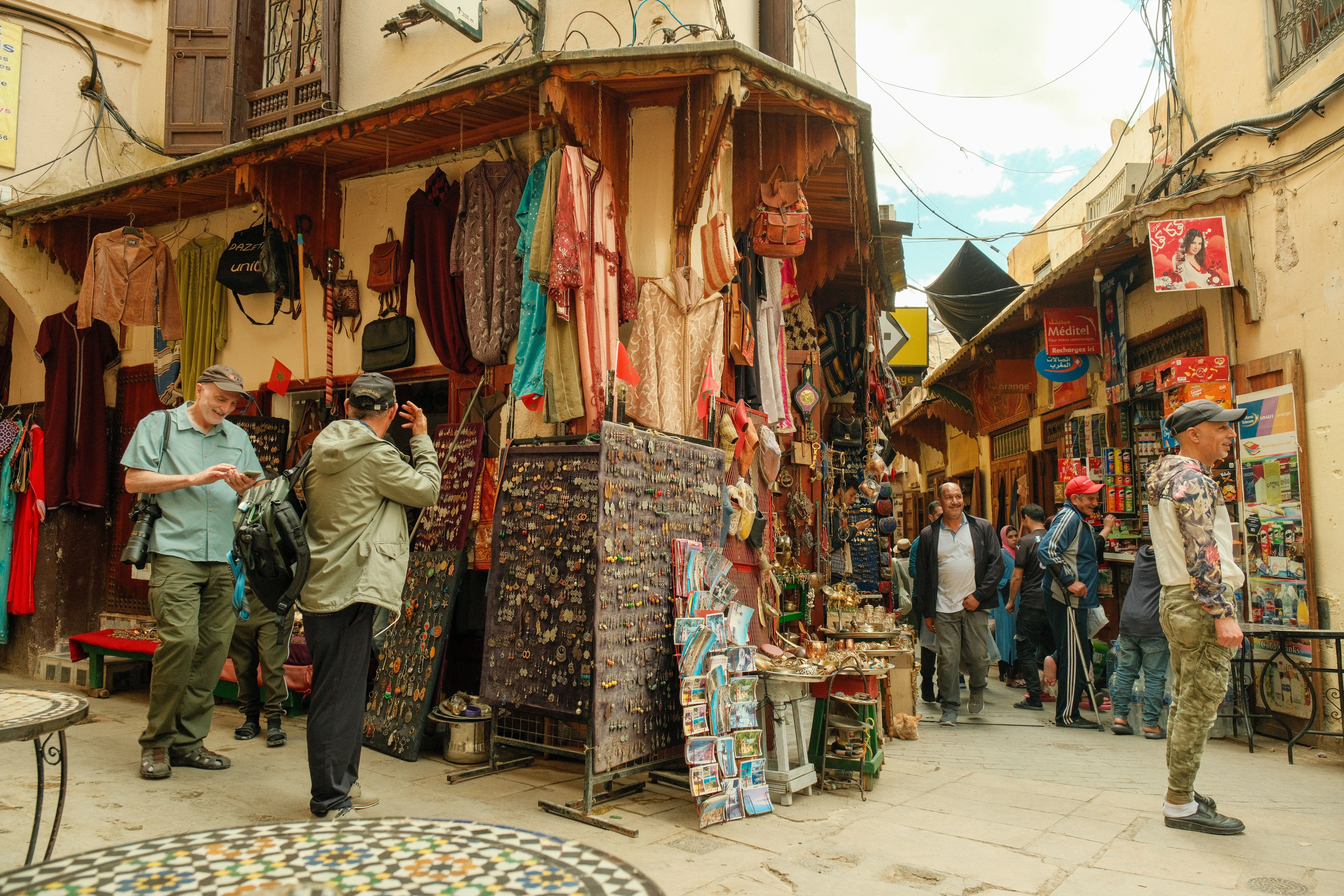 Travelers walking through a Moroccan medina street